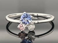 RING AUS 375/- WEIßGOLD MIT TANSANIT, GRANAT & DIAMANTEN