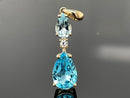ANHÄNGER AUS 375/- GELBGOLD MIT BLAUTOPAS BEH. & ZIRKON