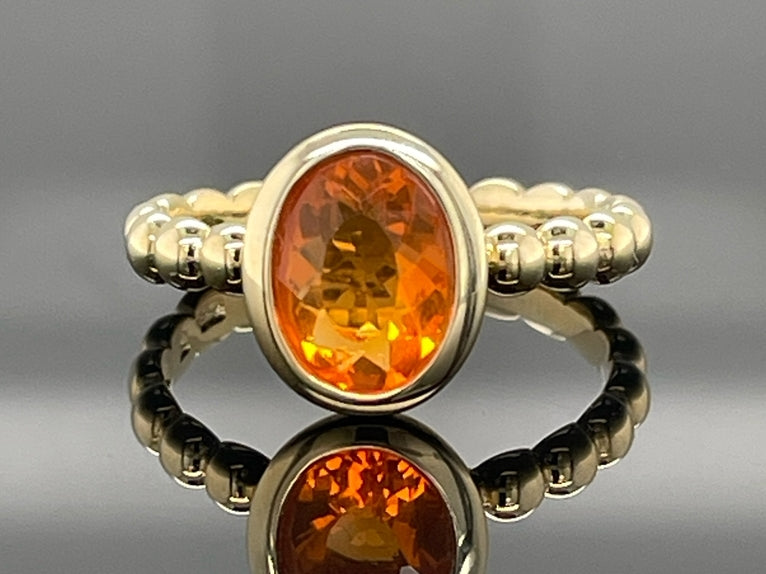 RING AUS 375/- GELBGOLD MIT FEUEROPAL (CA. 0,66 ct.)