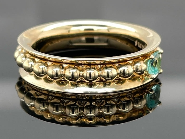 DREHRING AUS 375/- GELBGOLD MIT PARAIBATURMALIN (ca. 0,14 ct.)