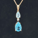 ANHÄNGER AUS 375/- GELBGOLD MIT BLAUTOPAS BEH. & ZIRKON